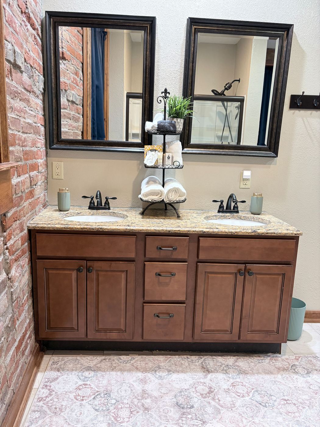 Double sink vanity with framed mirrors and fresh towels